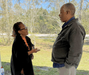 A woman and a man are talking at a Community BBQ